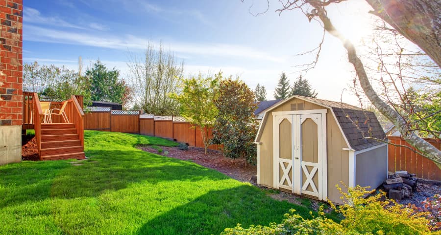 Fenced backyard with storage shed in Jackson